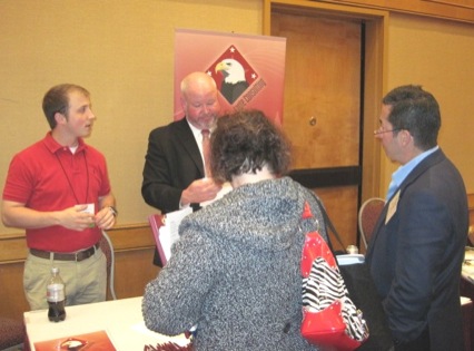 Attendees visiting the Eagle consulting booth